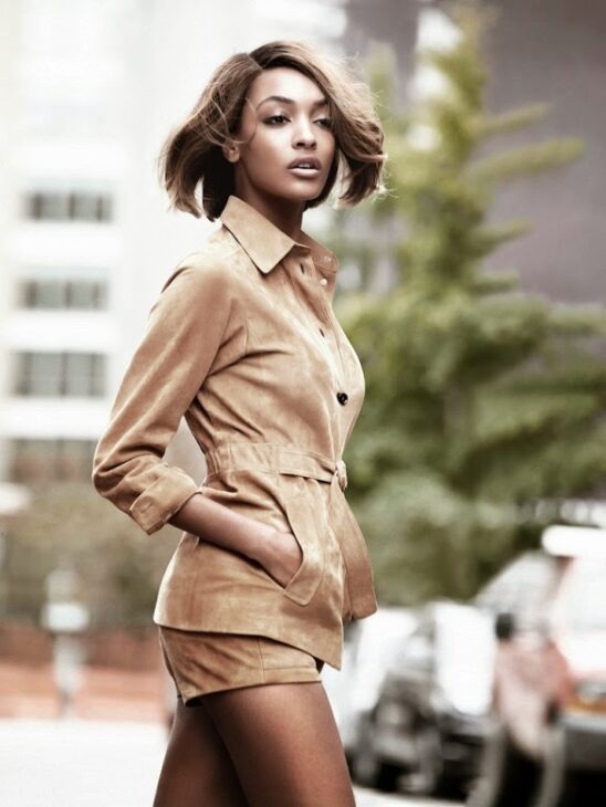 ourdan Dunn modelling designer looks with a short voluminous bob for Vogue UK.